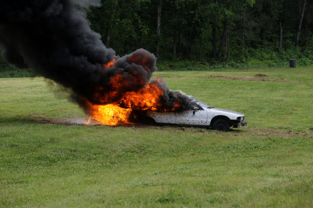Exploding car target on fire during a live-fire range event at Terra Bellum