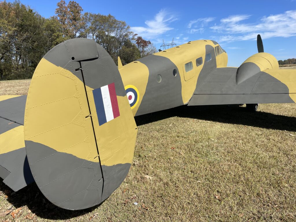 Rear tail fin and fuselage view of a vintage military Beechcraft Model 18 plane at Terra Bellum