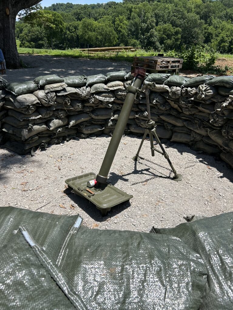 Military mortar display inside a sandbag artillery pit at Terra Bellum