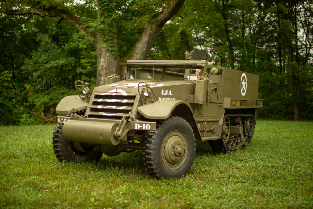 Authentic WWII US M3 Half-Track armored vehicle driving on the grass at Terra Bellum