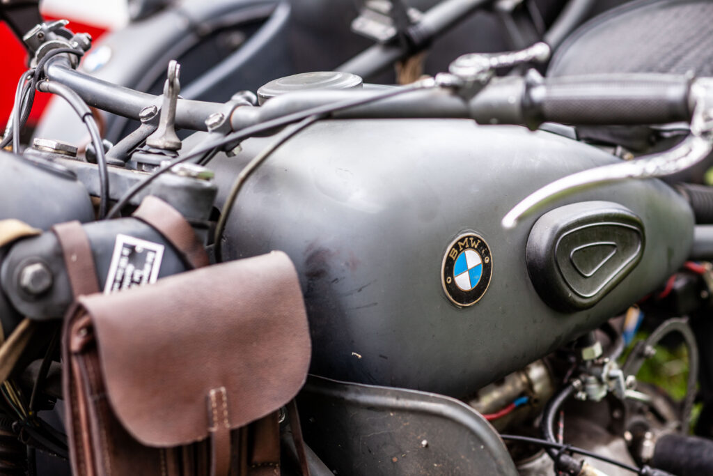 Close-up view of the BMW emblem on a vintage WWII military sidecar motorcycle at Terra Bellum
