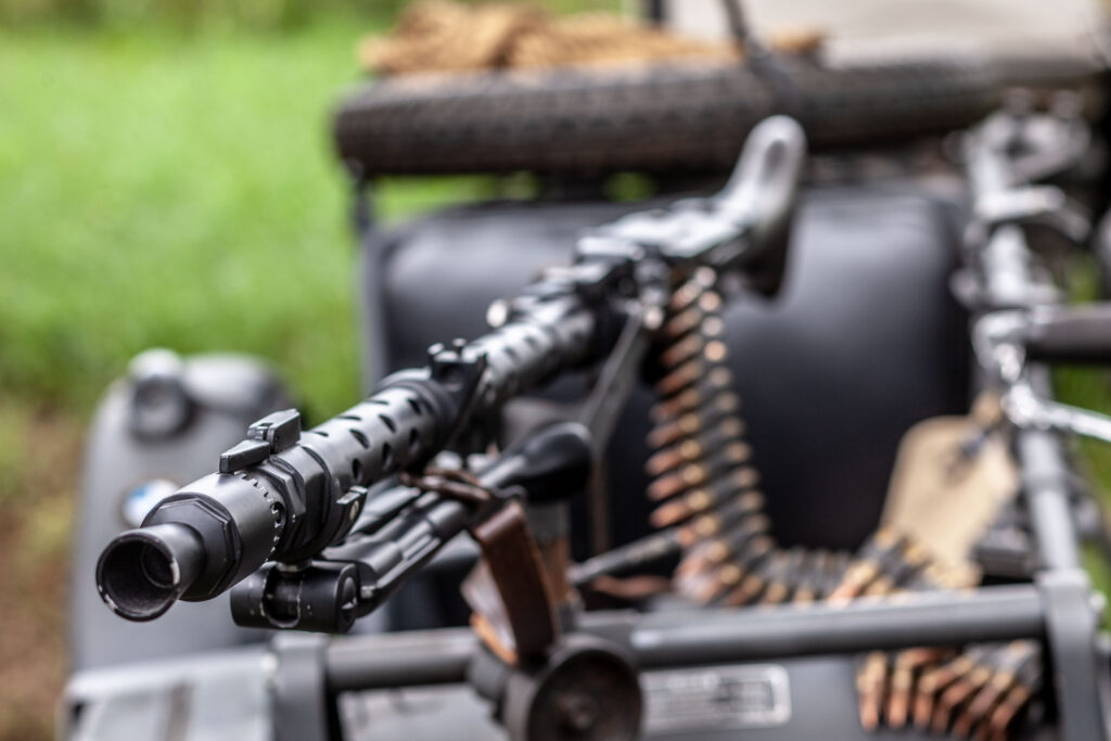 Detailed close-up of a belt-fed German MG34 machine gun with ammunition belt mounted at Terra Bellum
