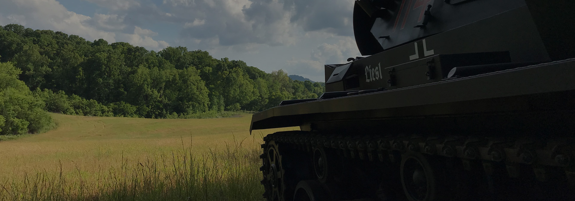 Authentic German Sturmgeschütz III (StuG III) assault gun driving in a rural field at Terra Bellum private estate